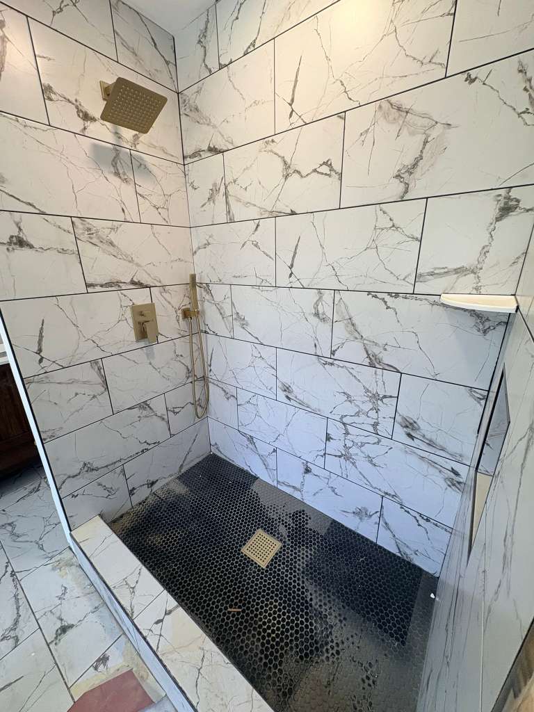 Double vanity with marble top and matte black faucets